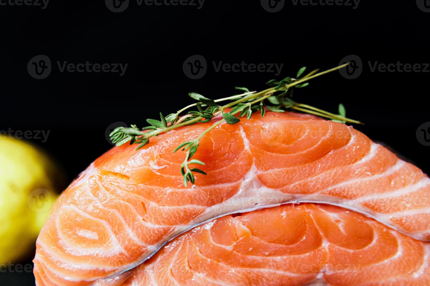 Fresh raw salmon fillet with seasonings and herbs photo