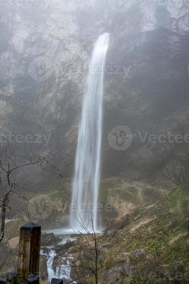 Small waterfall with milky white jets of water in Austrian woods. photo