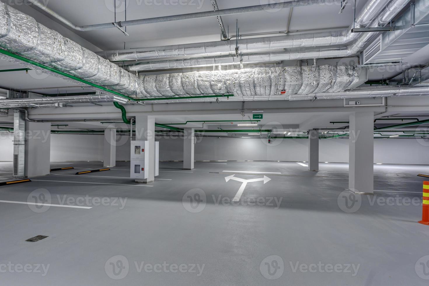 empty underground garage parking with columns and road markings photo