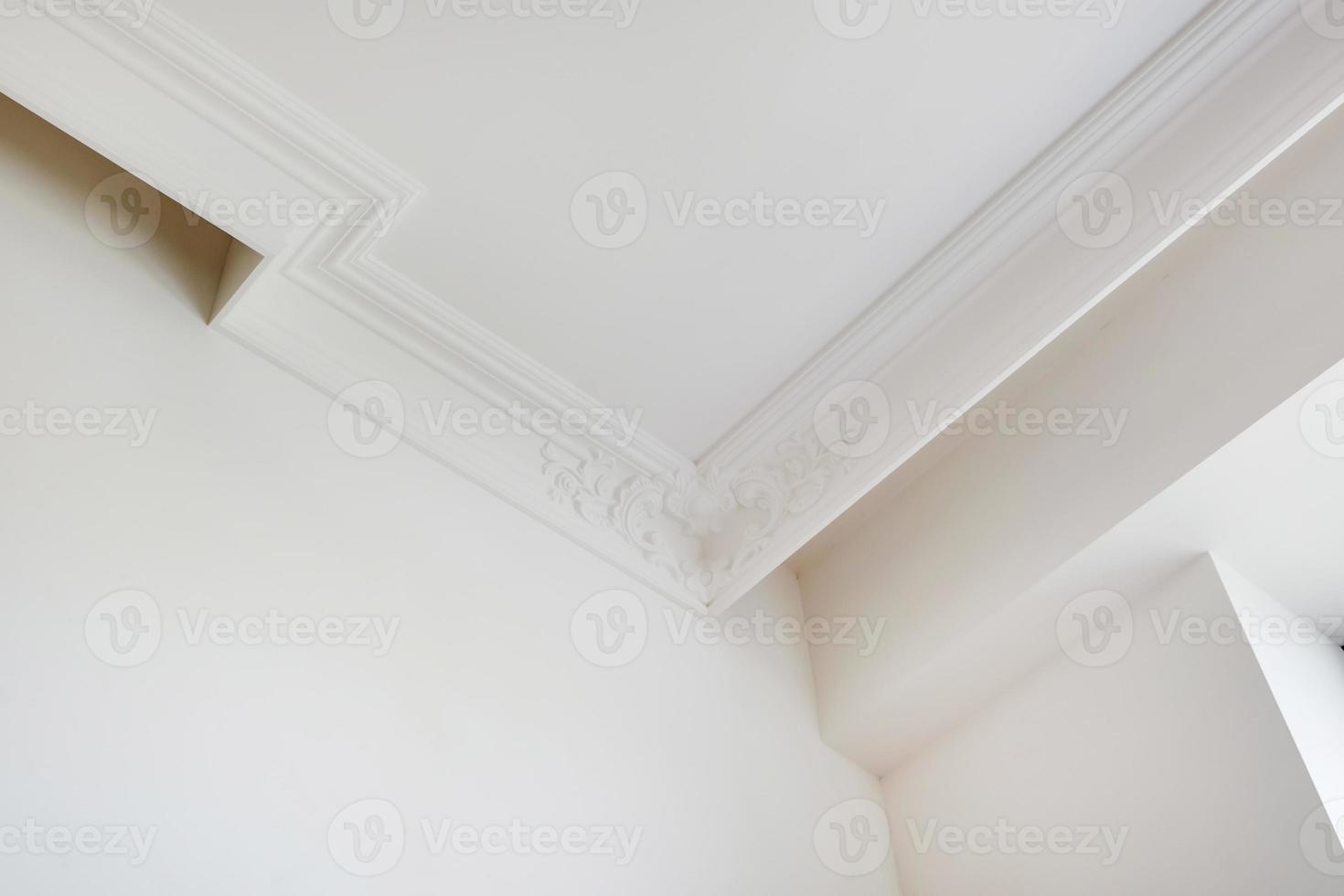 Detail of corner ceiling cornice with intricate crown molding. photo