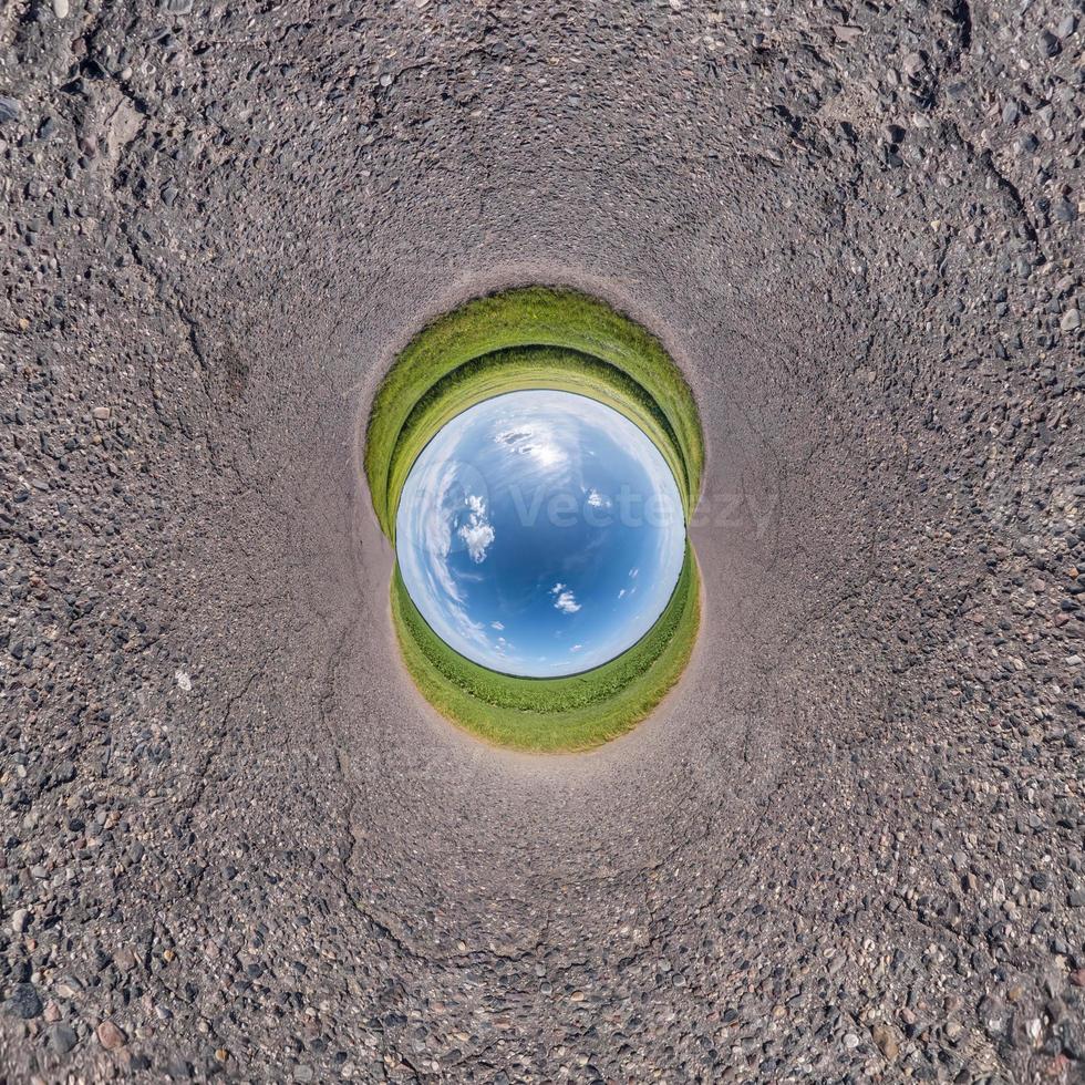 Inversion of little planet transformation of spherical panorama 360 degrees. Spherical abstract aerial view on field with awesome beautiful clouds. Curvature of space. photo