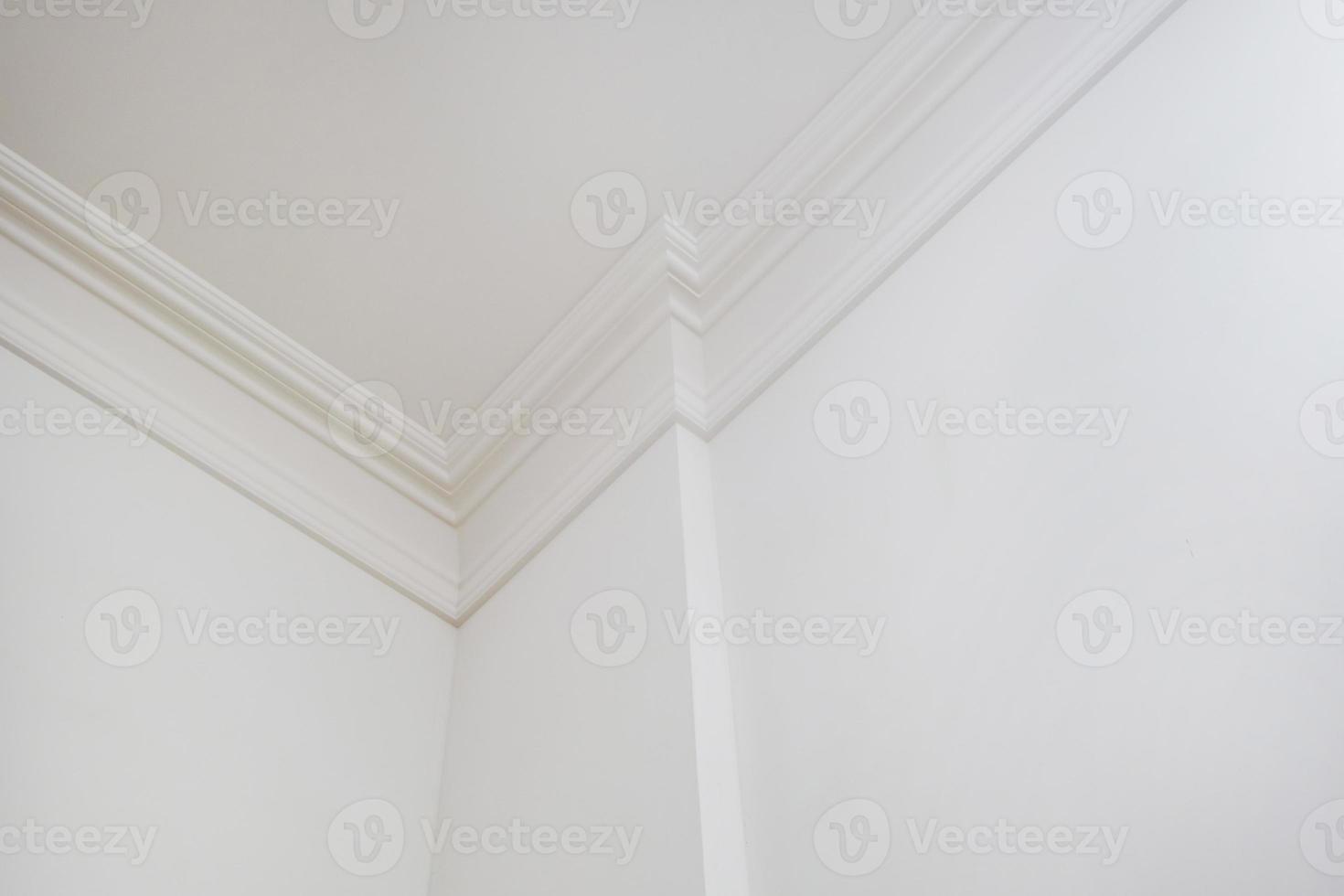 corner of ceiling and walls with intricate crown moulding. Interior construction and renovation concept. photo