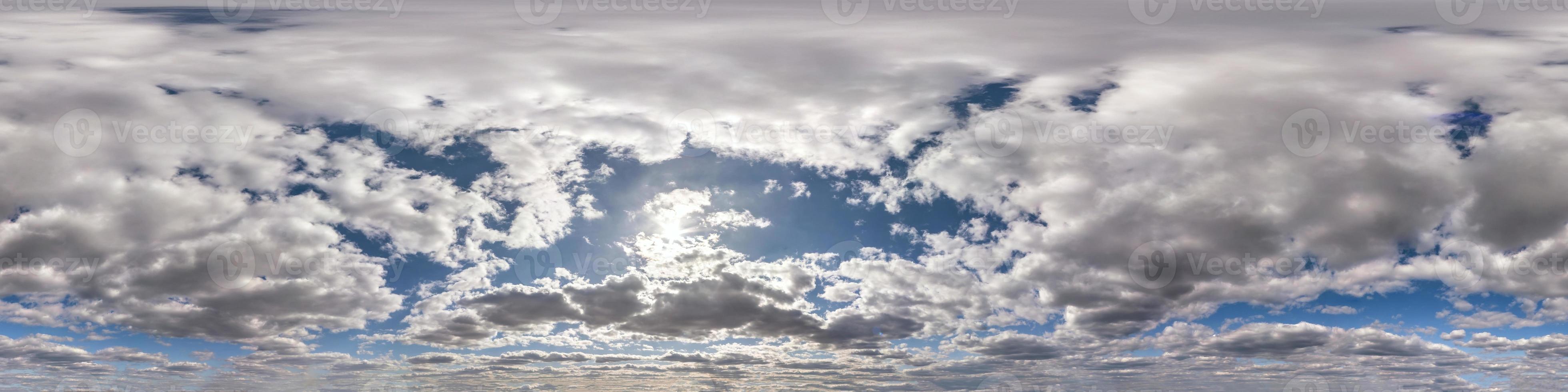 Seamless hdri panorama 360 degrees angle view blue sky with beautiful fluffy cumulus clouds with zenith for use in 3d graphics or game development as sky dome or edit drone shot photo