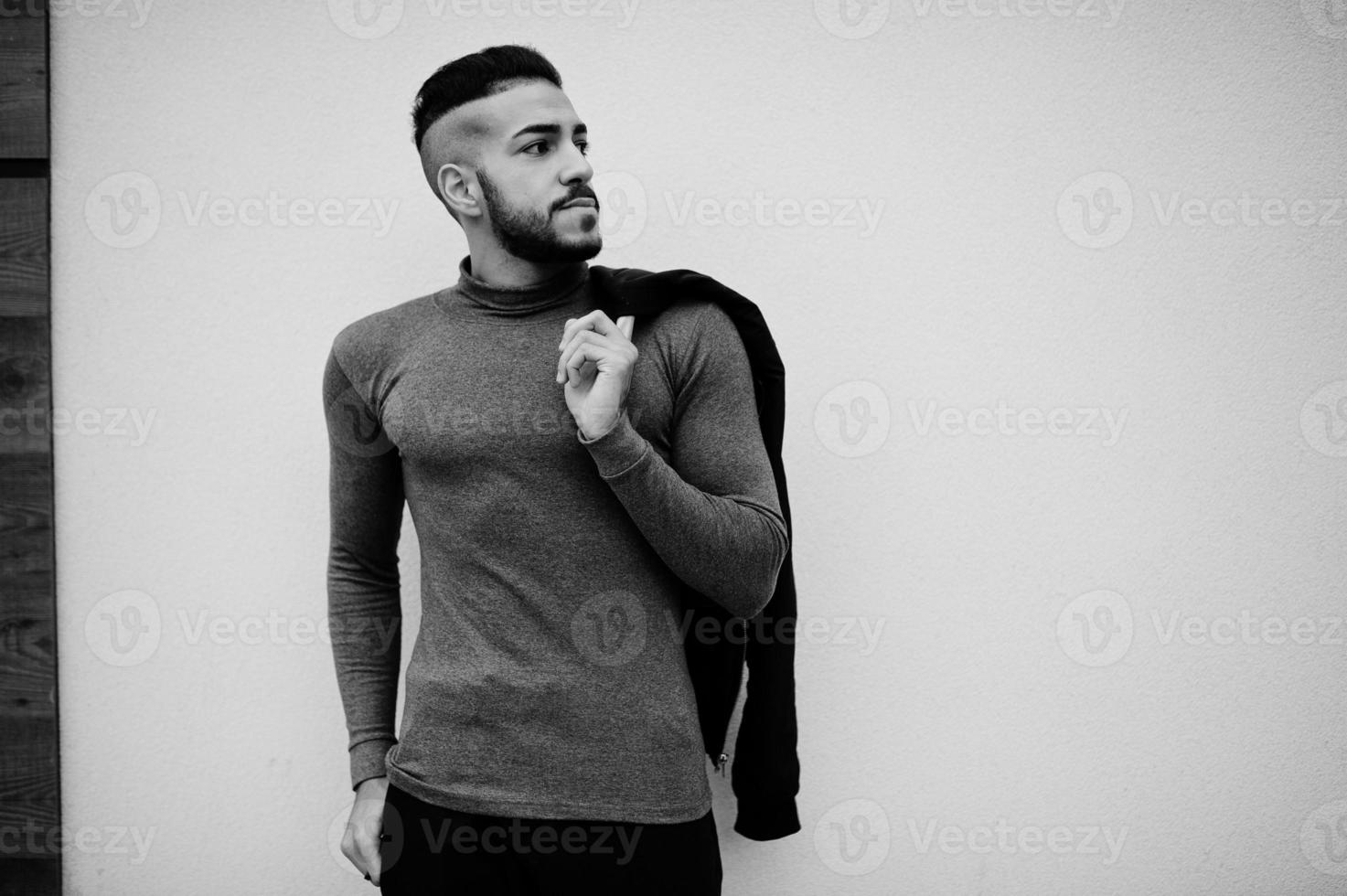 Portrait of stylish arab beard man wear grey turtleneck and black jaket. Arabian model guy. photo