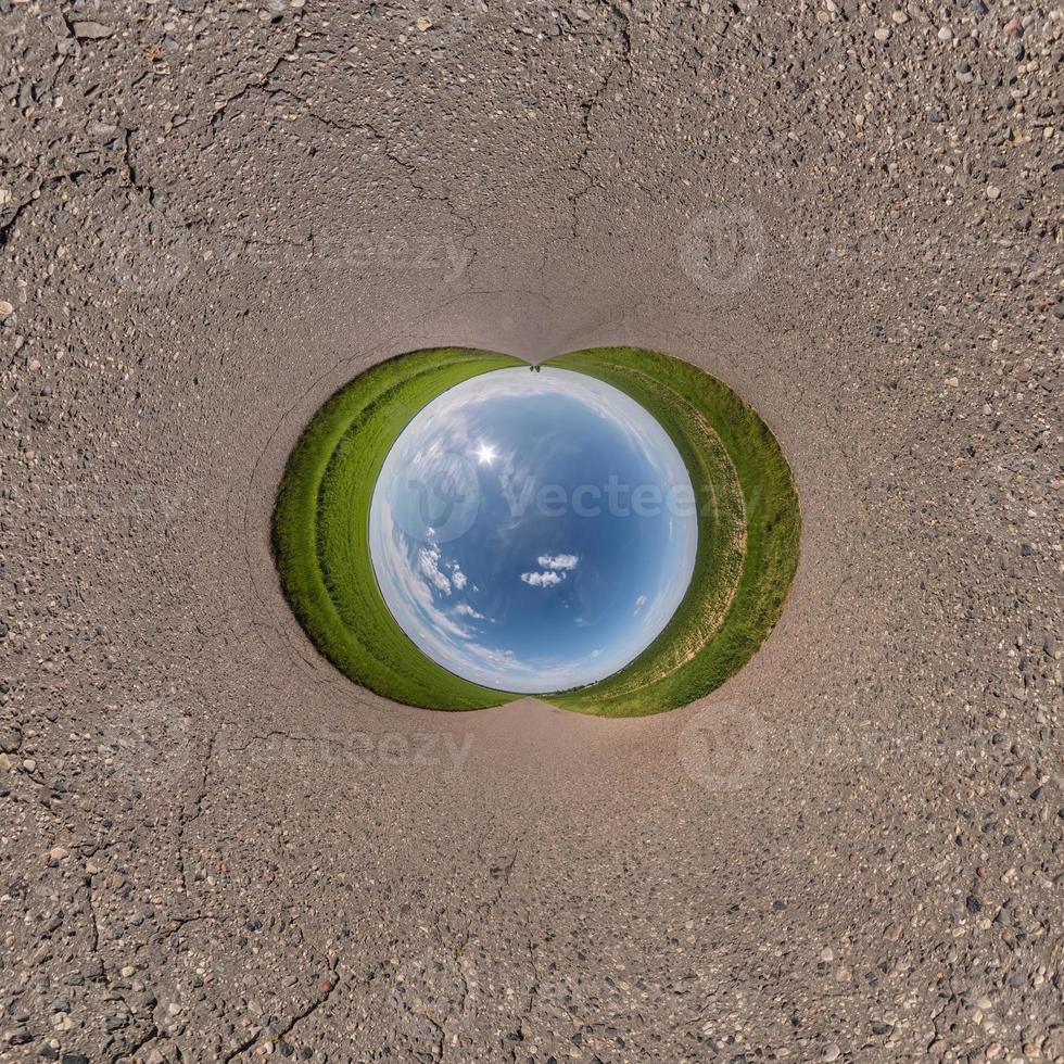 blue sky ball in middle of swirling asphalt road. Inversion of tiny planet transformation of spherical panorama 360 degrees. Spherical abstract view. Curvature of space. photo