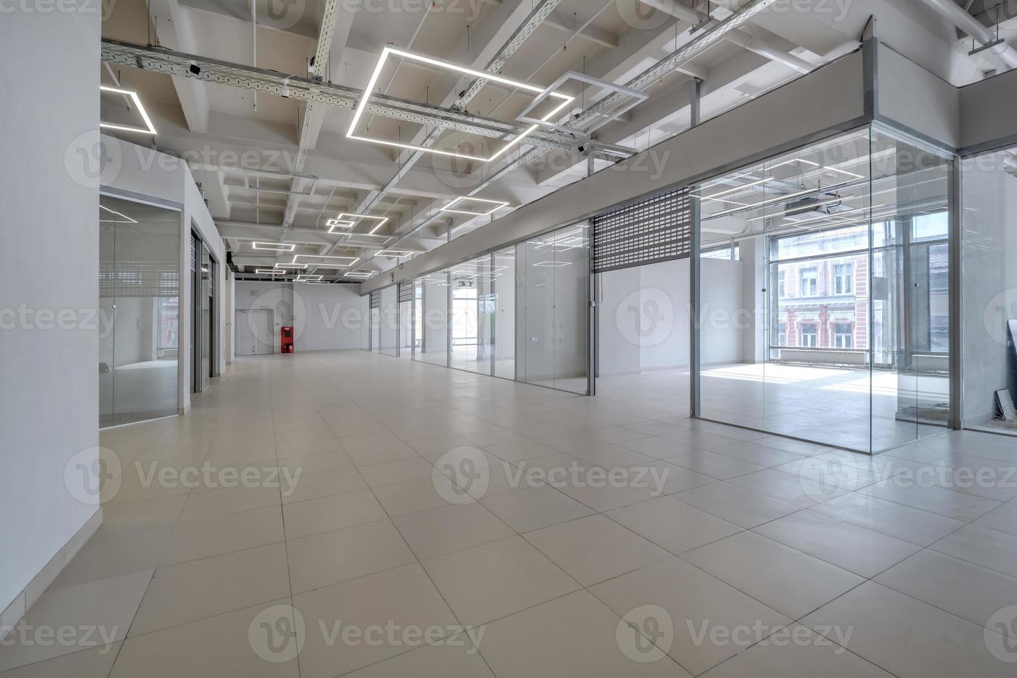 Modern white empty room interior with columns and panoramic windows.  room for office or store photo