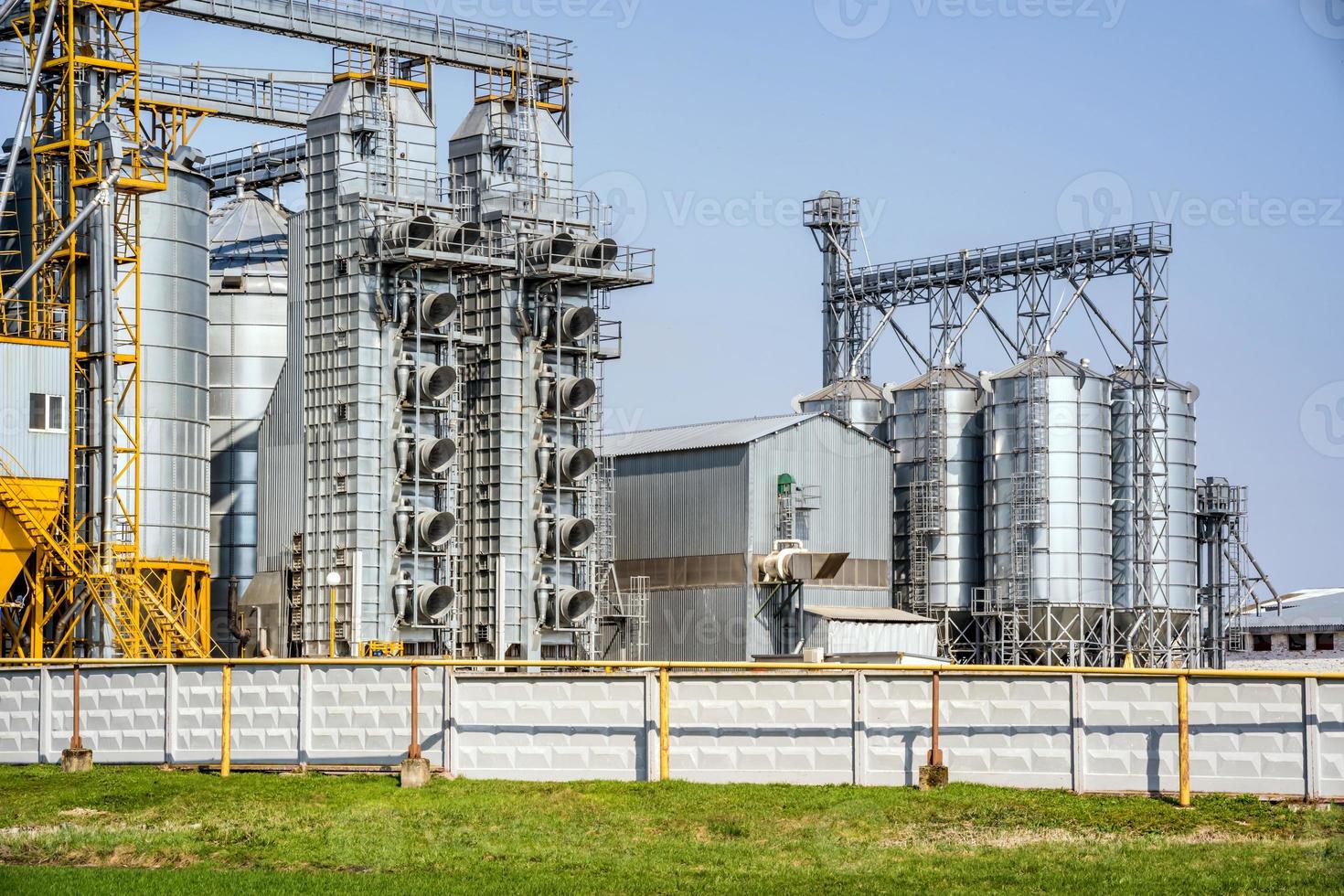 Modern Granary elevator. Silver silos on agro-processing and manufacturing plant for processing drying cleaning and storage of agricultural products, flour, cereals and grain. seed cleaning line photo