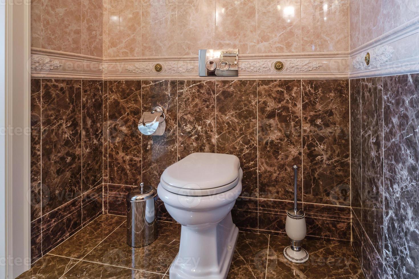 toilet and detail of a corner shower cabin with wall mount shower attachment photo