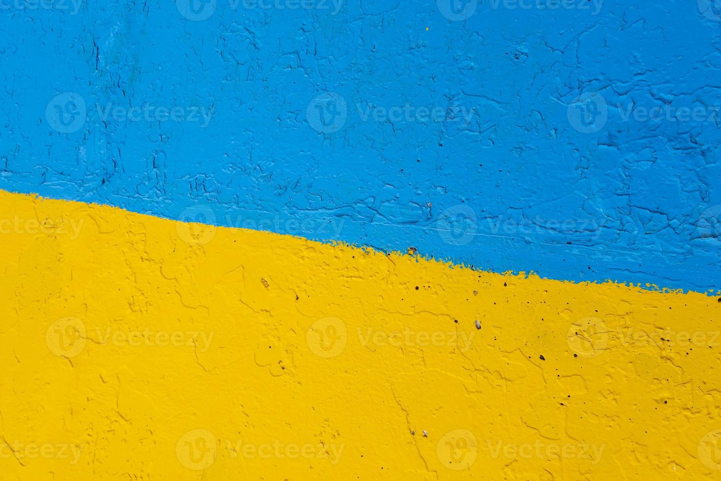 concrete wall painted in yellow and blue like Ukrainian flag, the country of victim of the aggressor photo