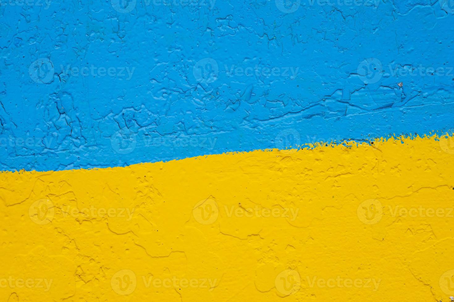 concrete wall painted in yellow and blue like Ukrainian flag, the country of victim of the aggressor photo