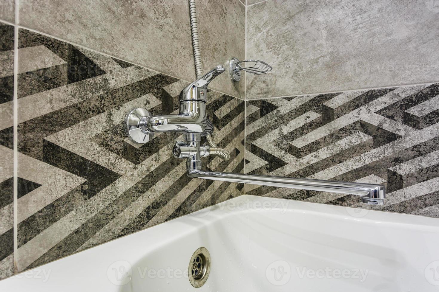 water tap sink with faucet in expensive loft bathroom. detail of a corner shower cabin with wall mount shower attachment photo