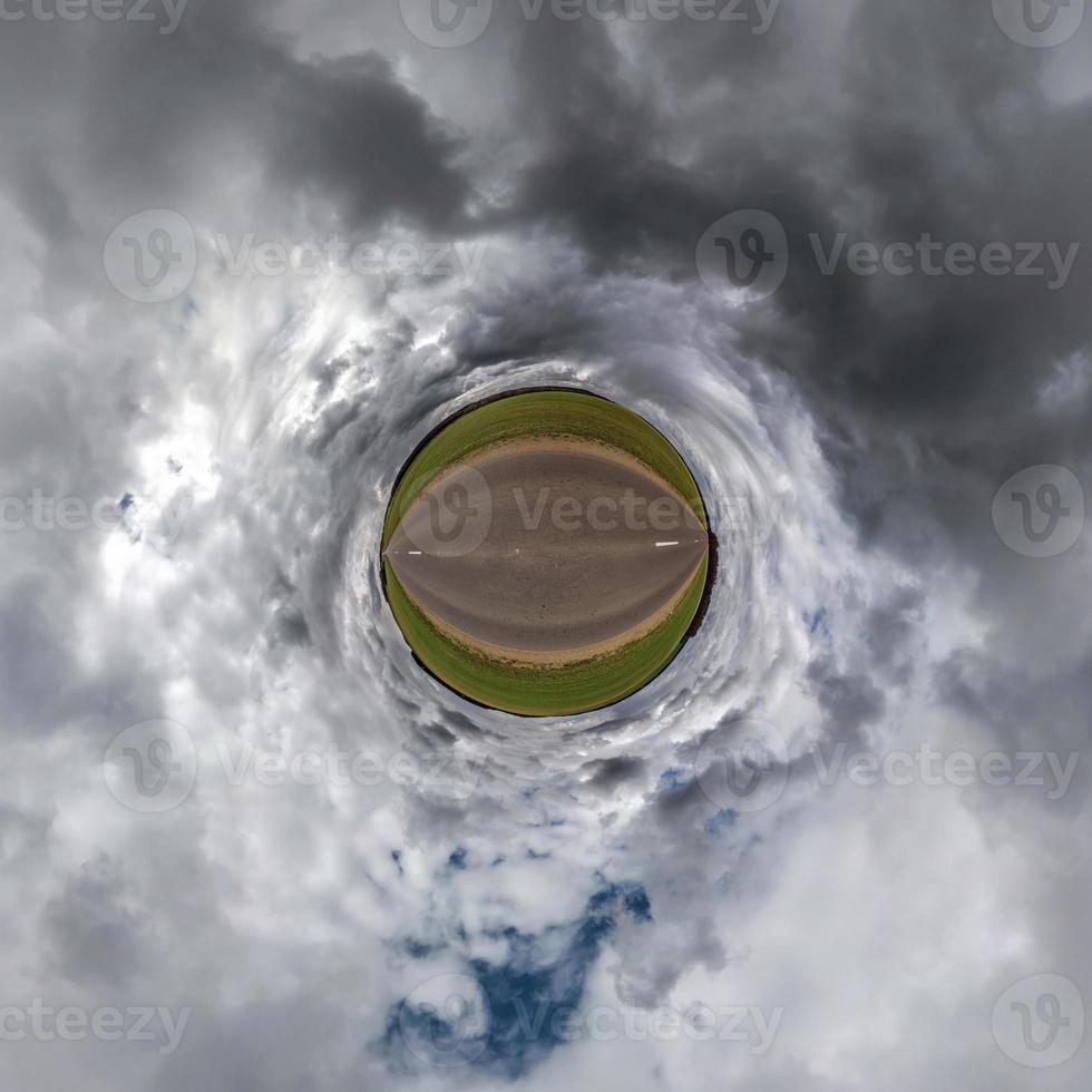 tiny planet in blue sky with beautiful clouds. Transformation of spherical panorama 360 degrees. Spherical abstract aerial view. Curvature of space. photo