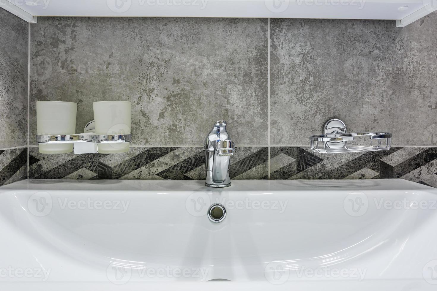 Ceramic Water tap sink with faucet with soap and shampoo dispensers in expensive loft bathroom or kitchen photo