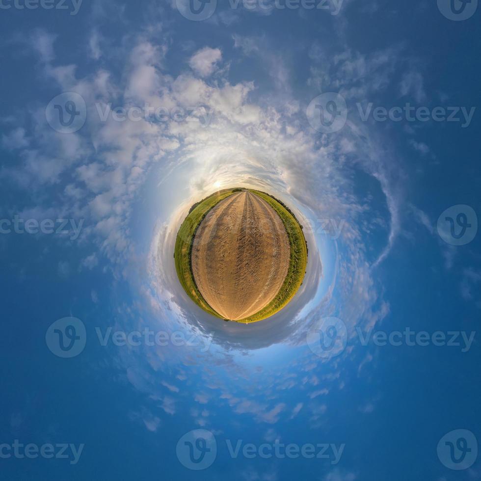 tiny planet in blue sky with beautiful clouds. Transformation of spherical panorama 360 degrees. Spherical abstract aerial view. Curvature of space. photo