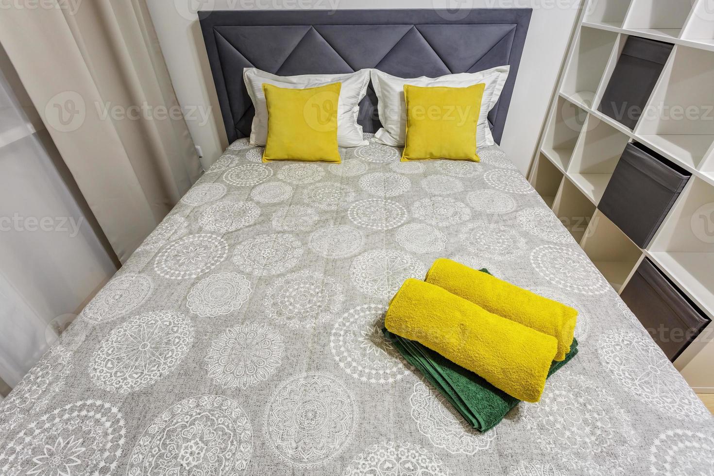 yellow pillows on a large double bed photo