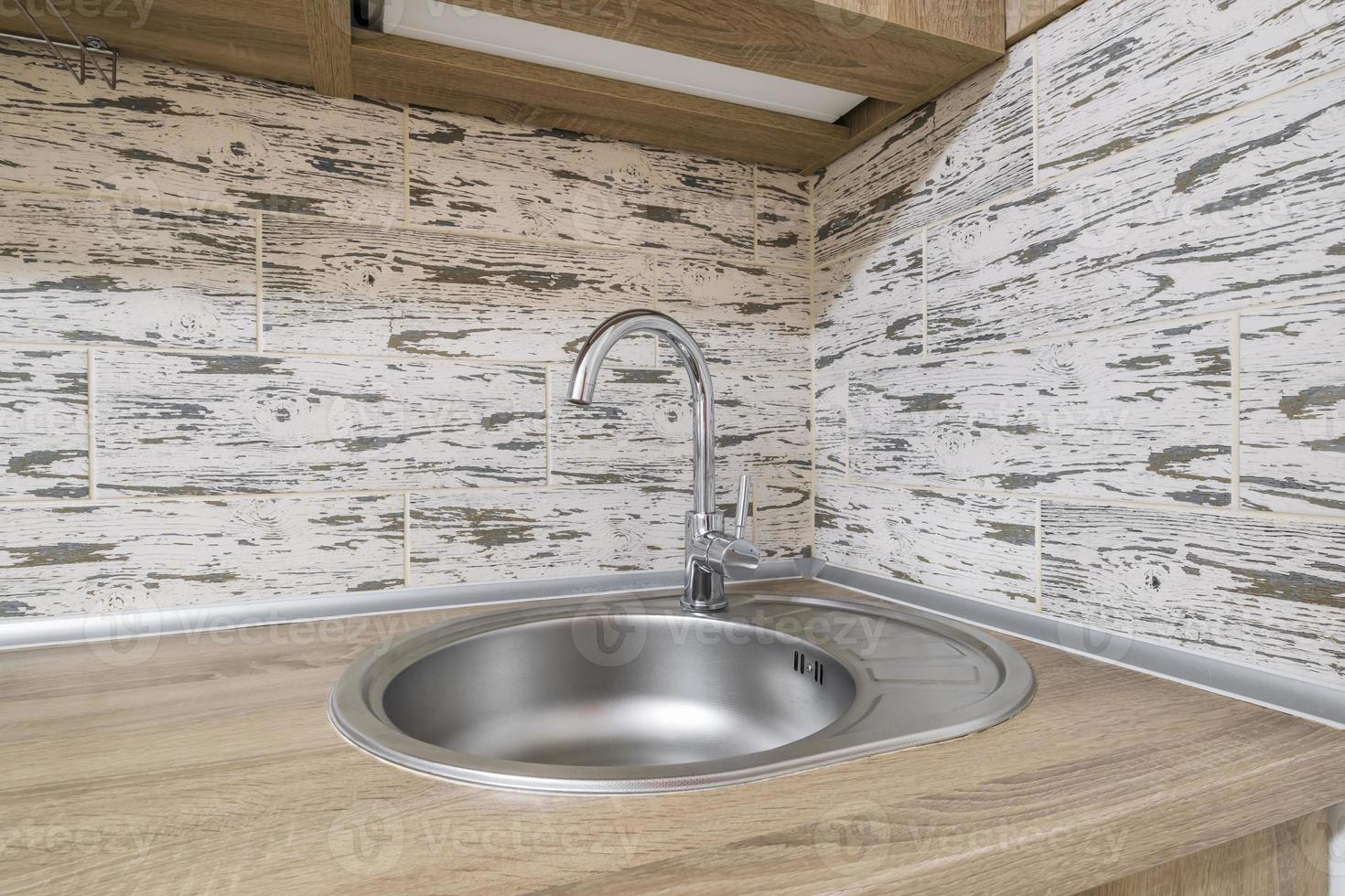 Water tap sink with faucet in expensive kitchen photo