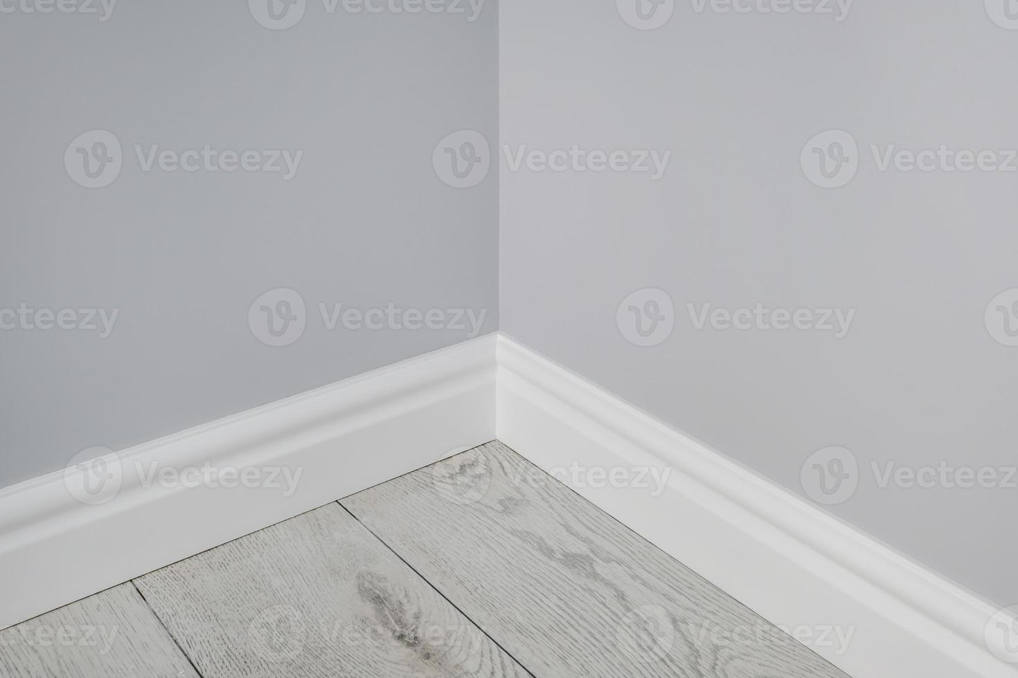 Detail of corner flooring with intricate crown molding and plinth. photo