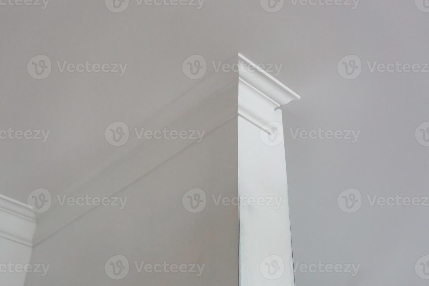 Detail of corner ceiling with intricate crown molding. photo