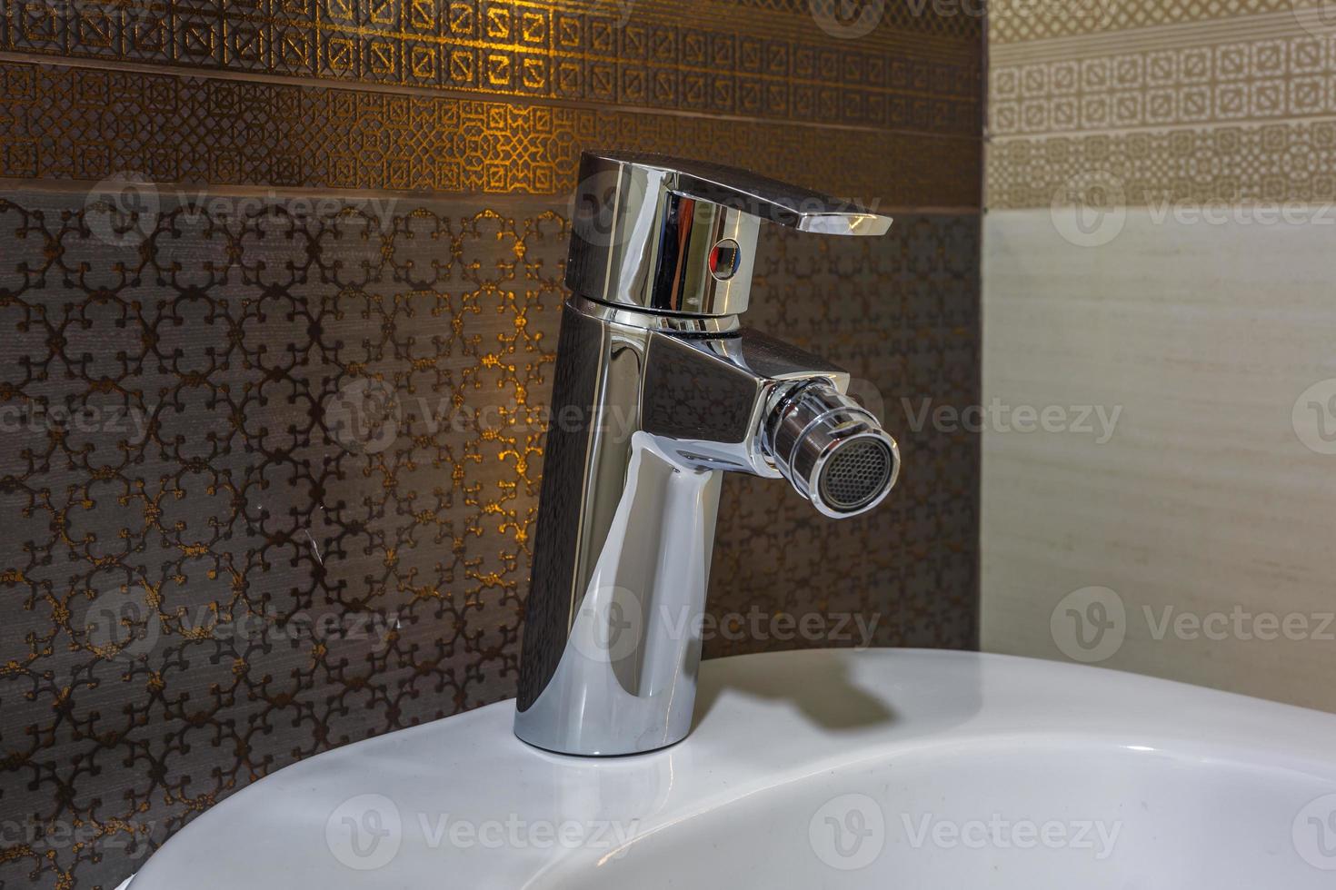 white ceramic washbasin with water tap sink with faucet in expensive bathroom photo