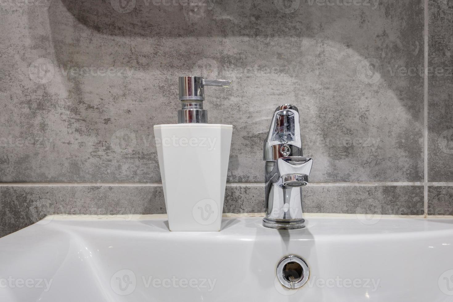 water tap sink with faucet in expensive bathroom photo