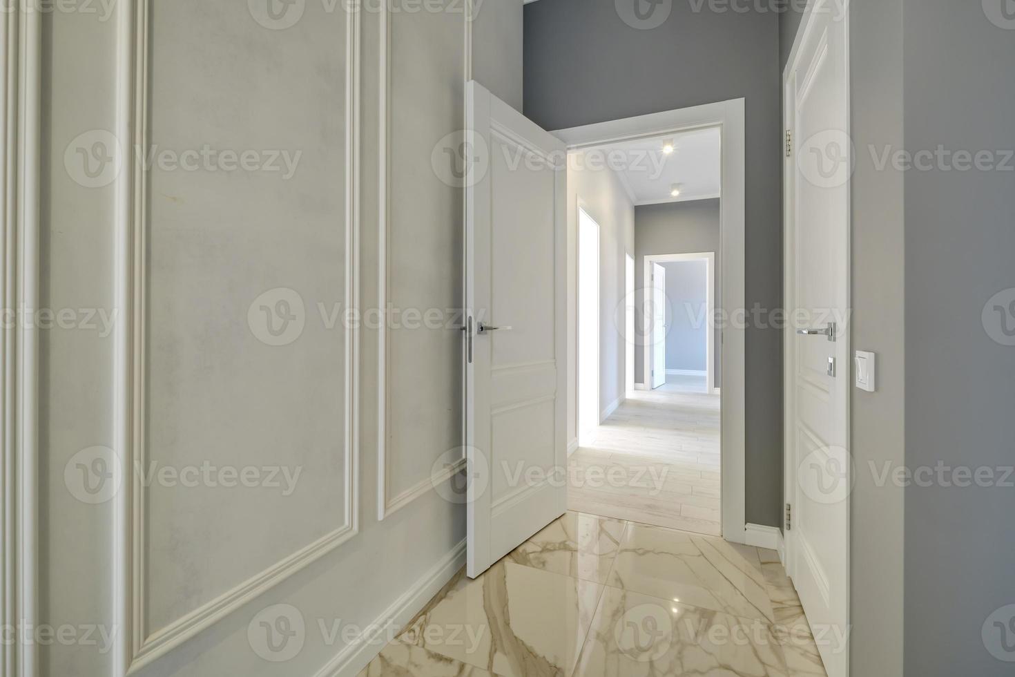 long white empty corridor in interior of entrance hall of modern apartments, office or clinic photo