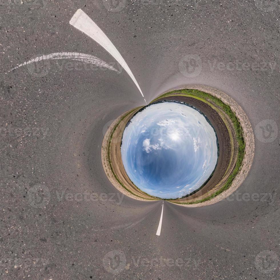 blue sky ball in middle of swirling asphalt road. Inversion of tiny planet transformation of spherical panorama 360 degrees. Spherical abstract view. Curvature of space. photo