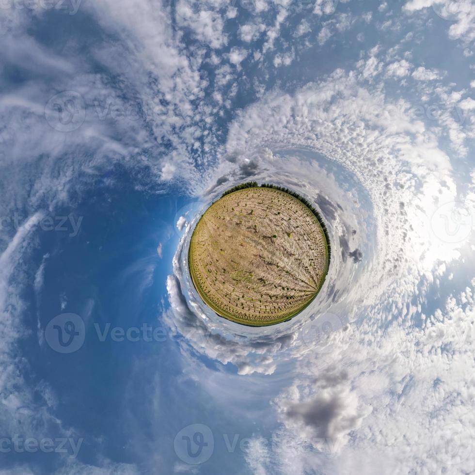 tiny planet transformation of spherical panorama 360 degrees. Spherical abstract aerial view in field with clear sky and awesome beautiful clouds. Curvature of space. photo