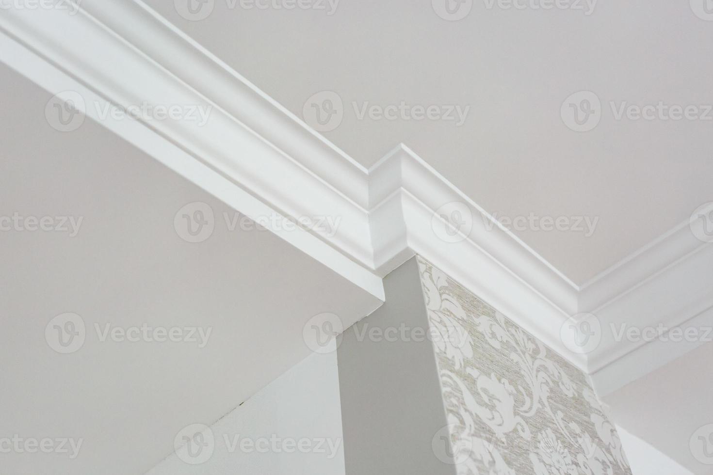 Detail of corner ceiling with intricate crown molding. photo