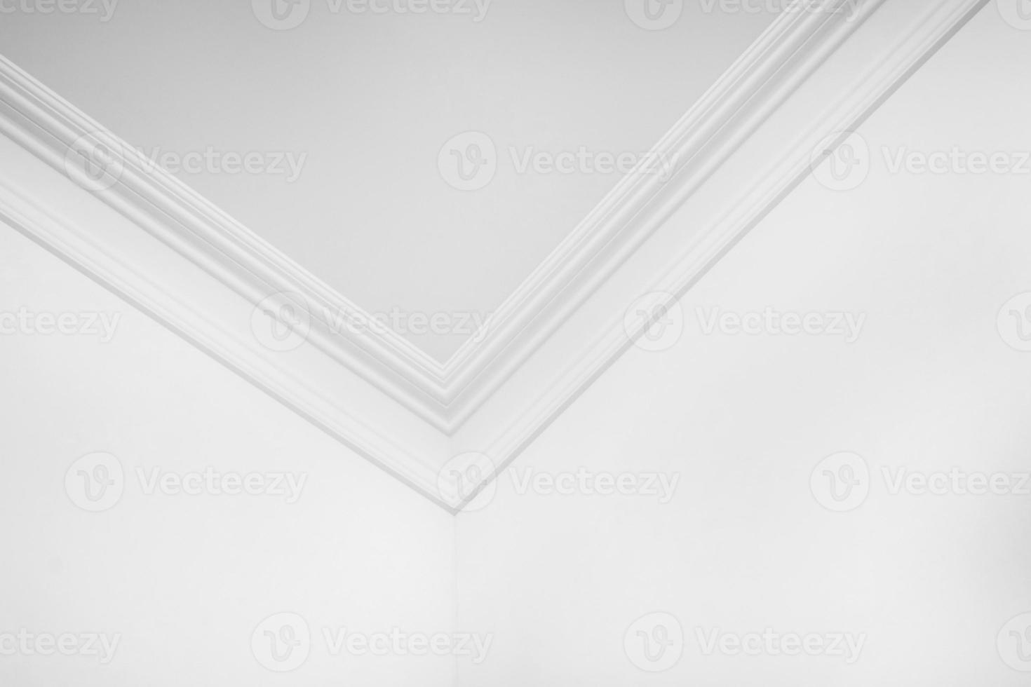 Detail of corner and ceiling cornice with intricate crown molding. photo