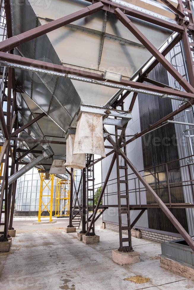 Modern Granary elevator. Silver silos on agro-processing and manufacturing plant for processing drying cleaning and storage of agricultural products, flour, cereals and grain. photo