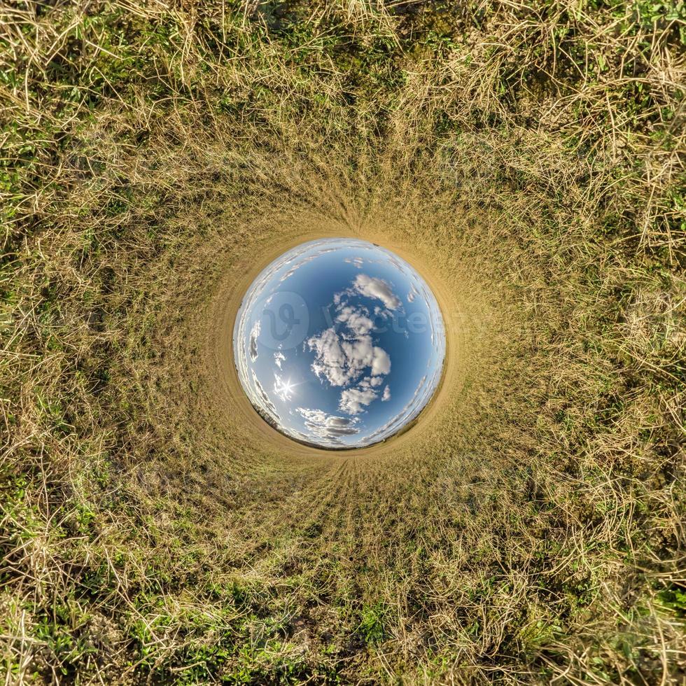 blue sky ball in middle of swirling field. Inversion of tiny planet transformation of spherical panorama 360 degrees. Curvature of space. photo