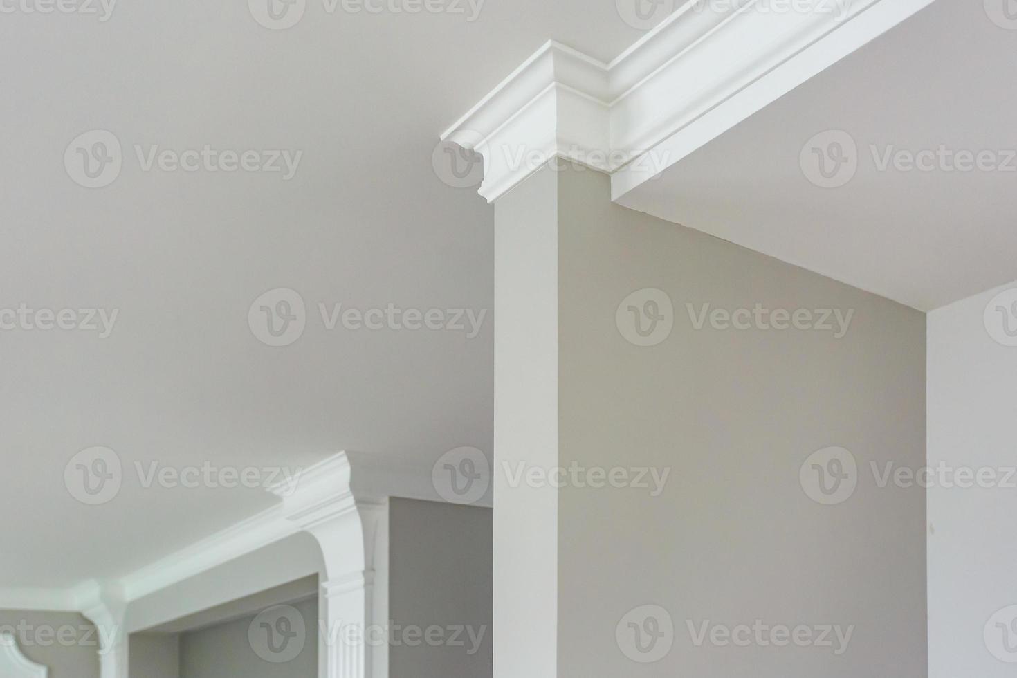 Detail of corner ceiling with intricate crown molding. photo