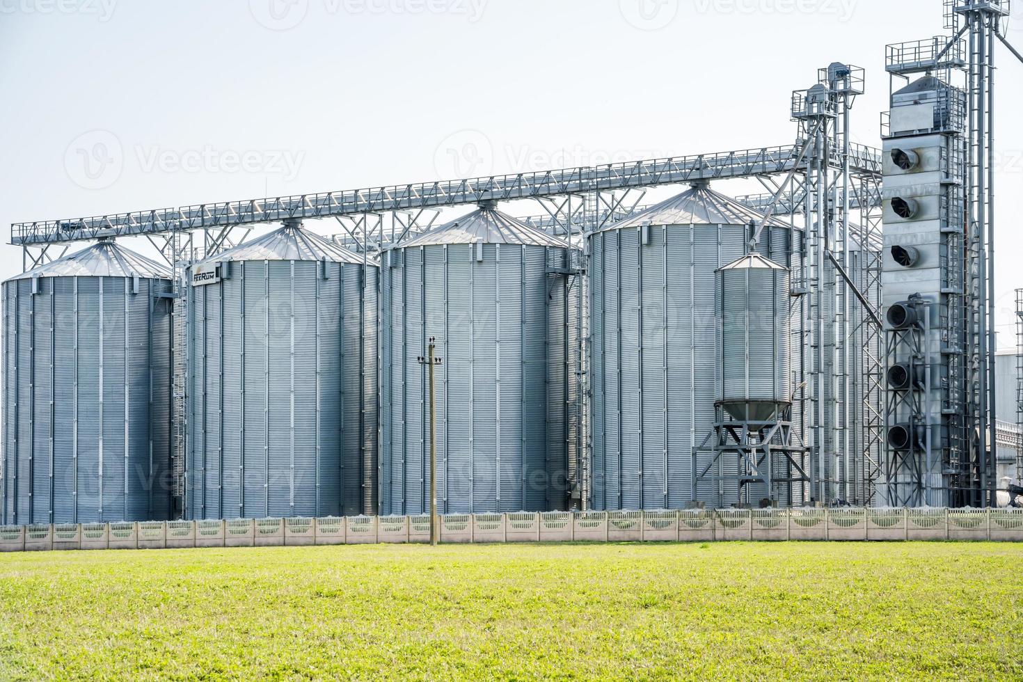 Modern Granary elevator. Silver silos on agro-processing and manufacturing plant for processing drying cleaning and storage of agricultural products, flour, cereals and grain. seed cleaning line photo