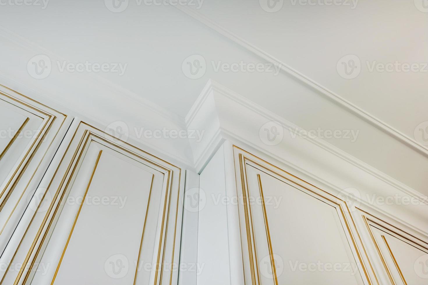 corner of ceiling and walls with intricate crown moulding. Interior construction and renovation concept. photo