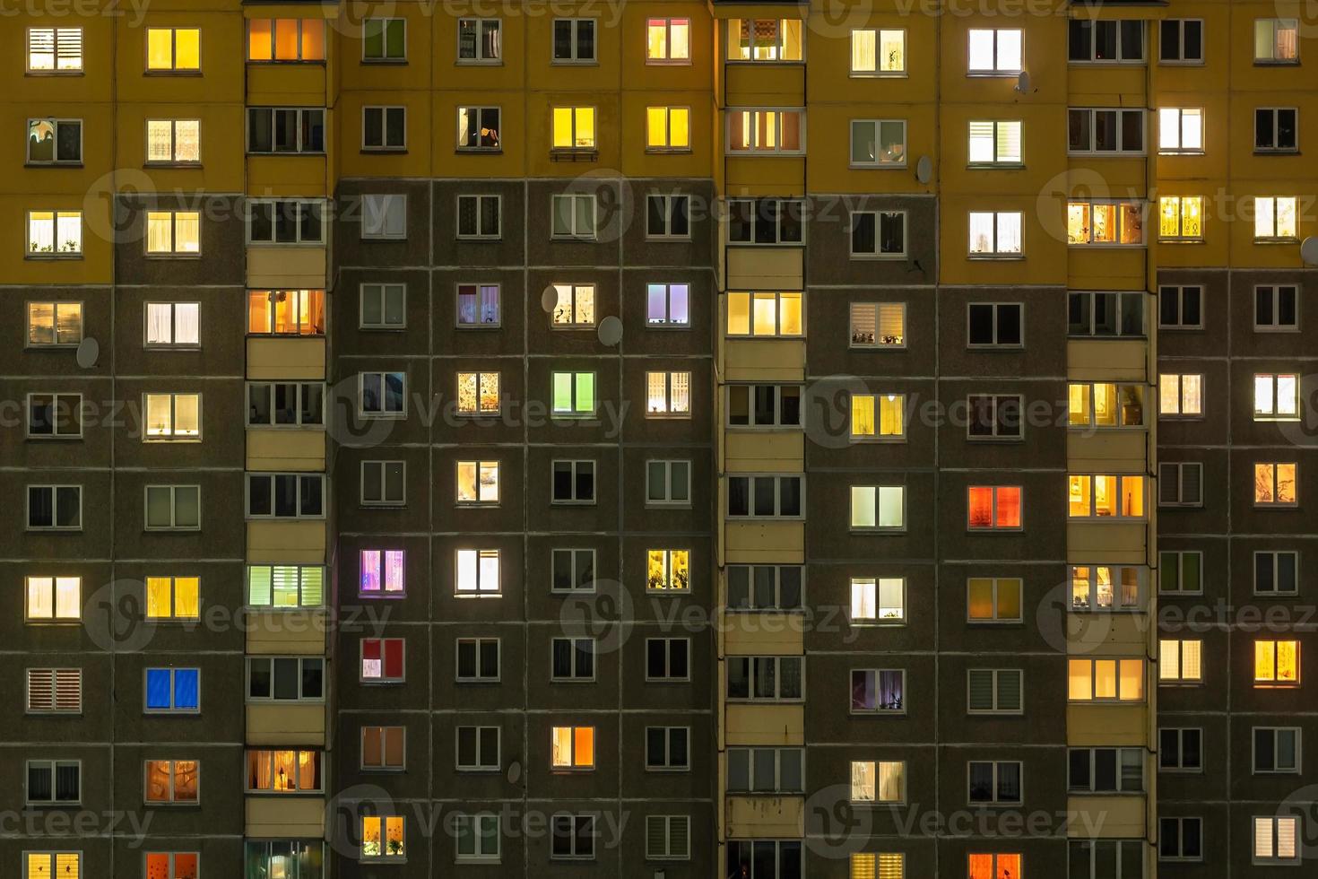 Flat night panorama of multicolor light in windows of multistory buildings. life in big city photo