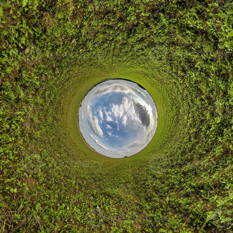 blue sky ball in middle of swirling field. Inversion of tiny planet transformation of spherical panorama 360 degrees. Curvature of space. photo
