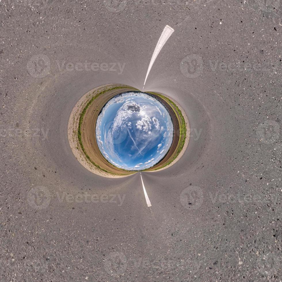 blue sky ball in middle of swirling field. Inversion of tiny planet transformation of spherical panorama 360 degrees. Curvature of space. photo