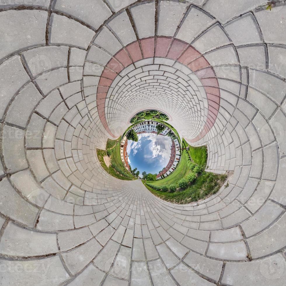 Inversion of blue little planet transformation of spherical panorama 360 degrees. Spherical abstract aerial view on field with awesome beautiful clouds. Curvature of space. photo