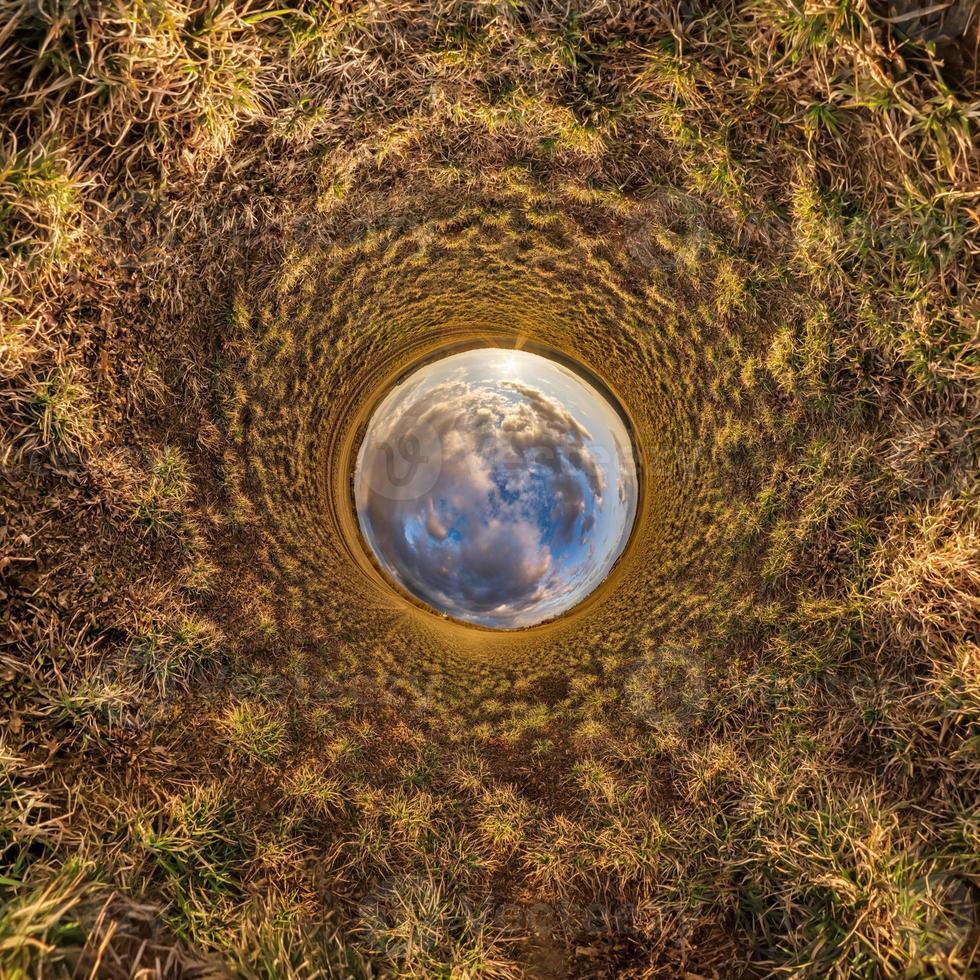 blue sphere little planet inside gravel road or field background. photo