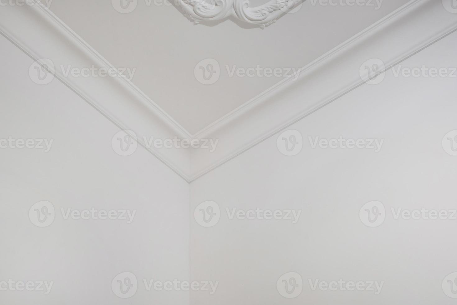 corner of ceiling and walls with intricate crown moulding. Interior construction and renovation concept. photo