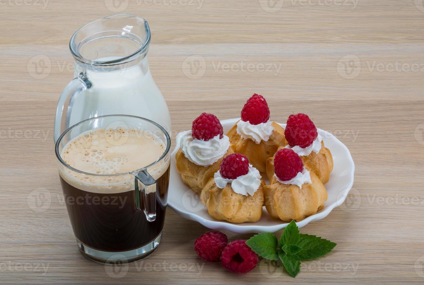 Profiterole with raspberry photo