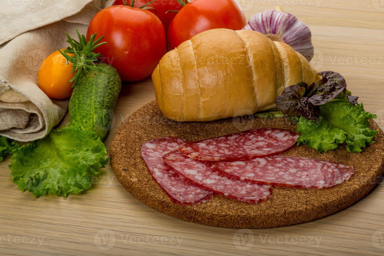 Salami on wooden plate photo