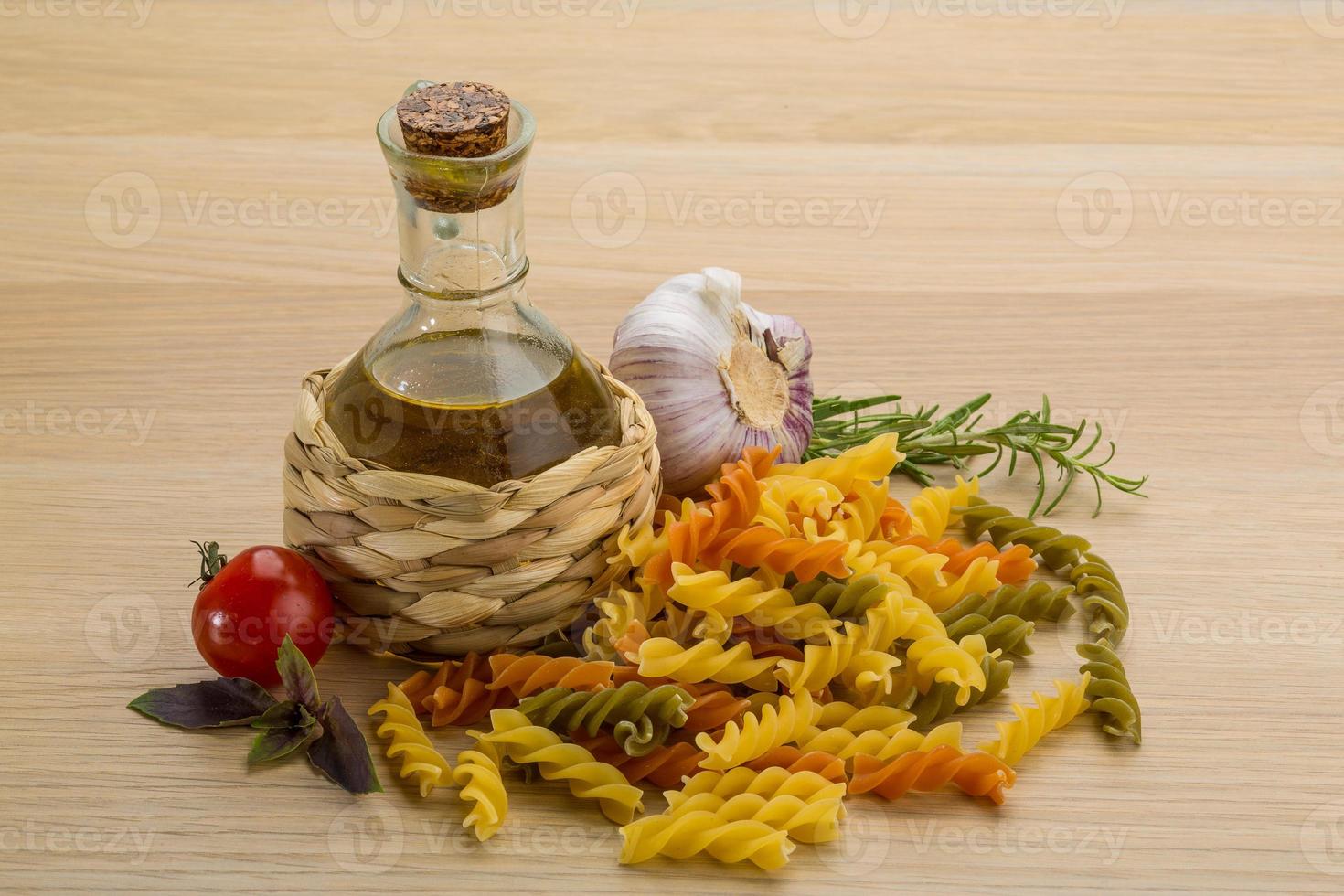 Fusilli on wooden background photo