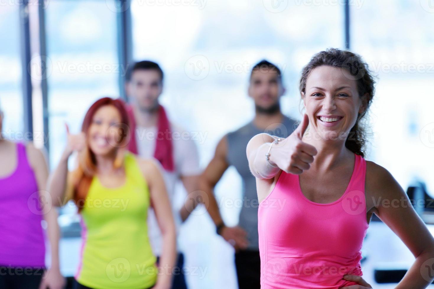 Group of people exercising at the gym photo