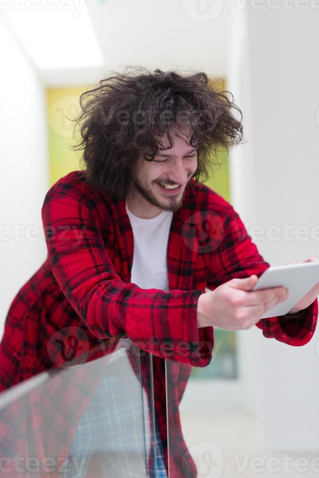 young freelancer using tablet computer photo