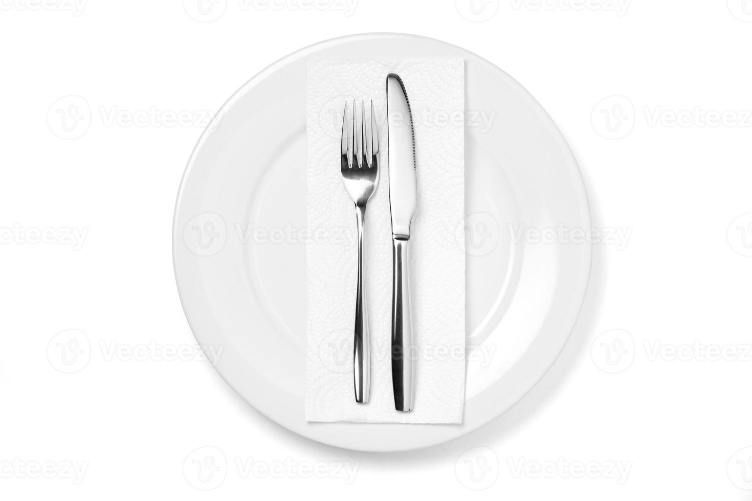 Empty plate with knife and fork isolated on a white background. photo