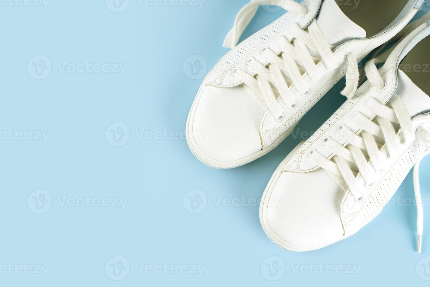 White sneakers on blue background photo