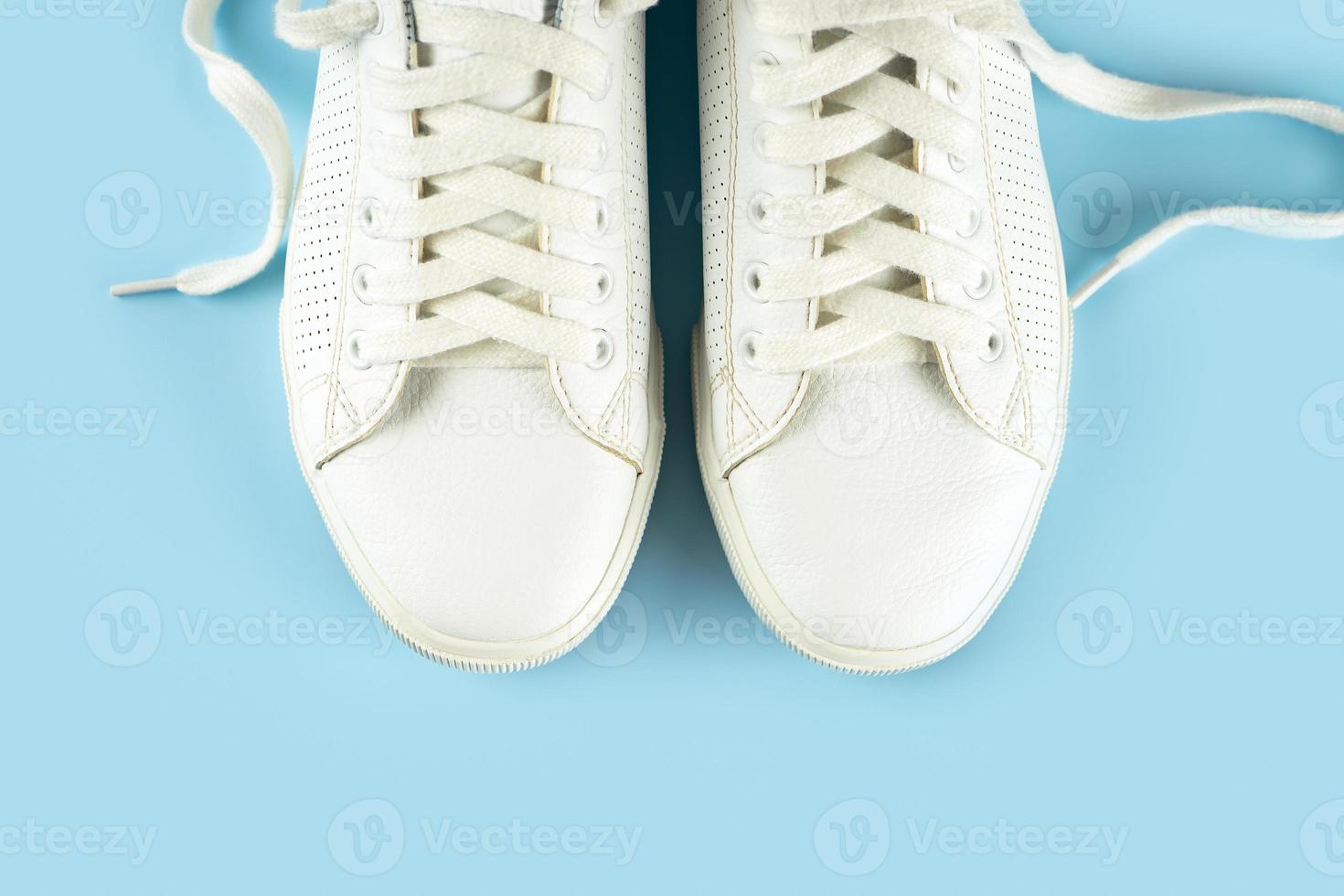 White sneakers on blue background photo