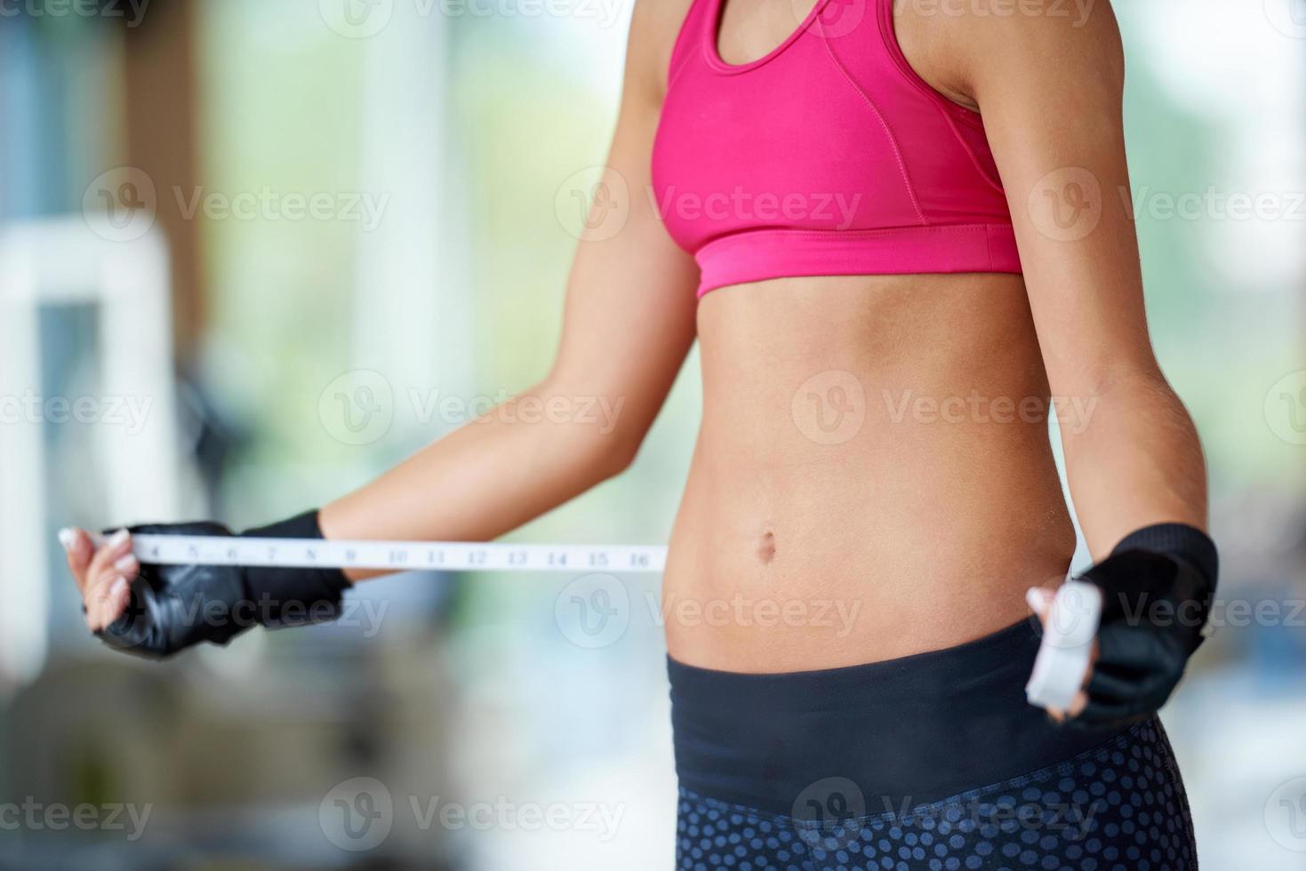 young fit woman measuring belly 10942724 Stock Photo at Vecteezy