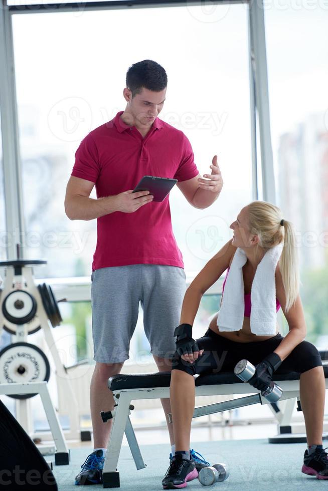 young sporty woman with trainer exercise weights lifting photo